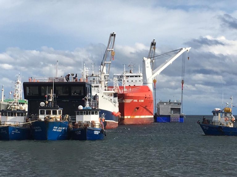 169m high general cargo ship “HHL Kobe” delivers four feed barges for Chilean salmon farmers, Australis and Multiexport