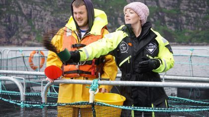 Matt Ross and Cherry Healey feeding salmon 2