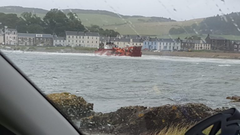 Workboat driven onto beach after slipping its anchor